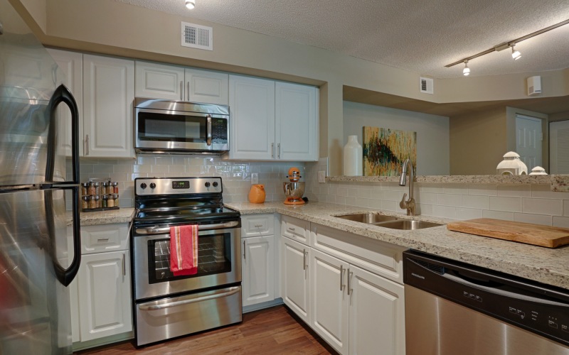 Classic apartments with Gooseneck faucet, Stainless Steel Appliances and  Shaker Style Cabinets.